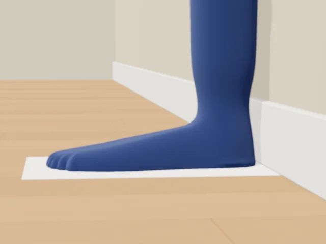 Side view: the foot on the sheet with a gap of about a centimetre between the heel and the skirting board.