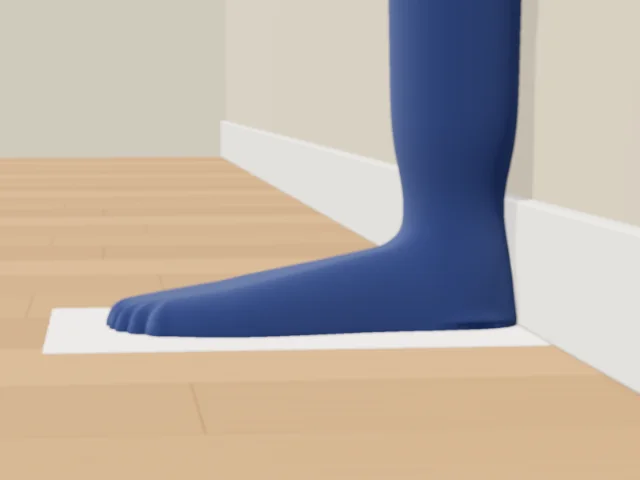 Side view: the foot on the sheet with the back of the heel pressed against the skirting board.